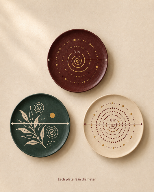 Three round decorative plates in dark reddish brown, deep green, and warm cream, each with hand-painted circular and botanical patterns. The plates are displayed on a textured beige background with dimension arrows indicating an 8-inch diameter, and text at the bottom reads 'Each plate: 8 in diameter'.