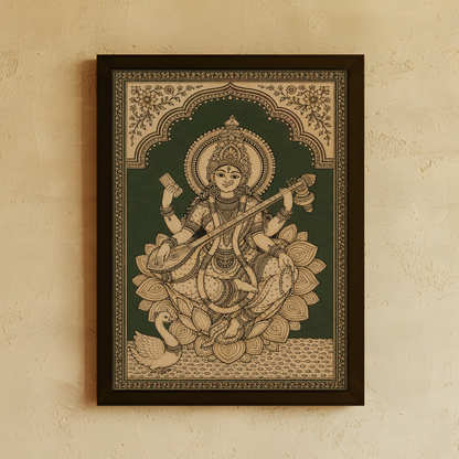 A framed Indian folk art print of Goddess Saraswathi seated on a lotus, displayed on a textured beige wall.