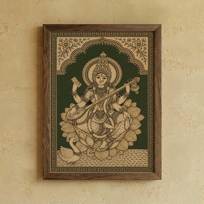 A wooden framed Indian folk art print of Goddess Saraswathi seated on a lotus, mounted on a textured beige plaster wall.