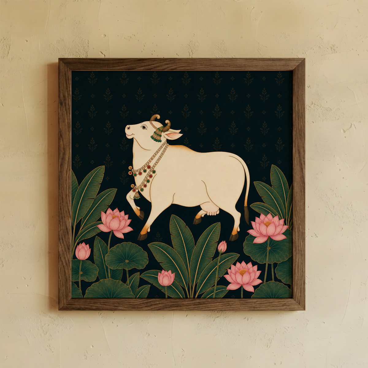A framed art print featuring a traditional Indian illustration of a white cow (Gaurav) adorned with a decorative necklace, walking among green lotus leaves and pink lotus flowers on a dark background, mounted on a textured beige wall.