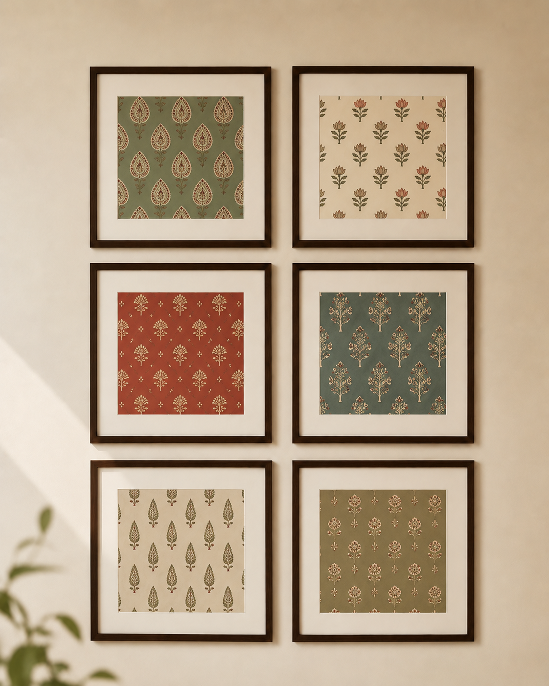 Six framed art prints with traditional Indian motifs in muted green, red, and beige tones, arranged in a 2x3 grid on a warm beige wall.