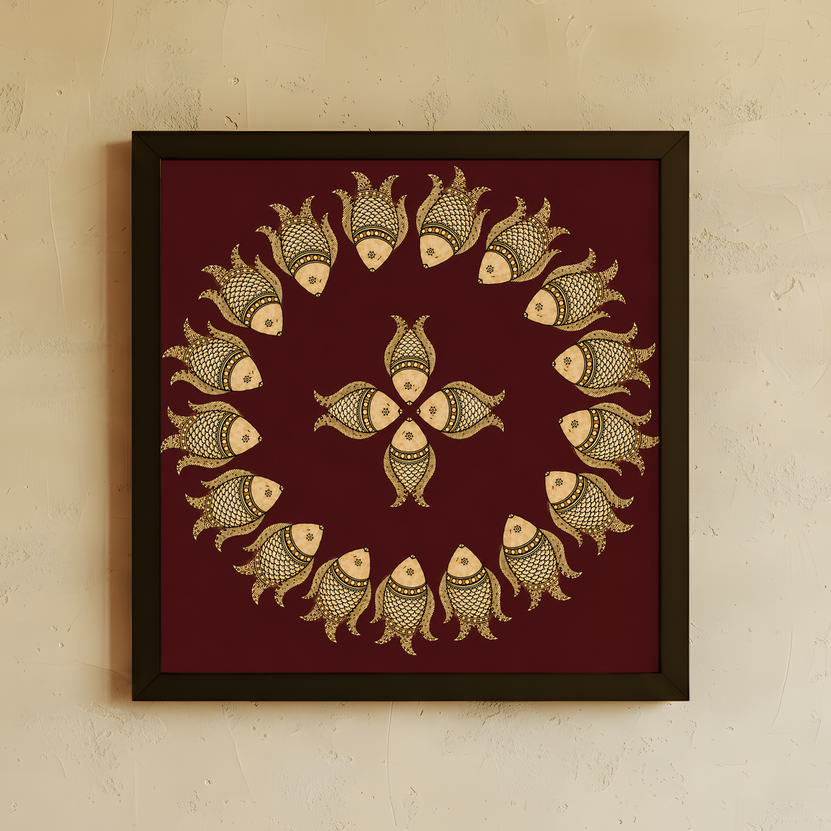 Framed wall art featuring a circular arrangement of stylized fish motifs in beige and gold on a deep maroon background, hung on a light beige textured wall.